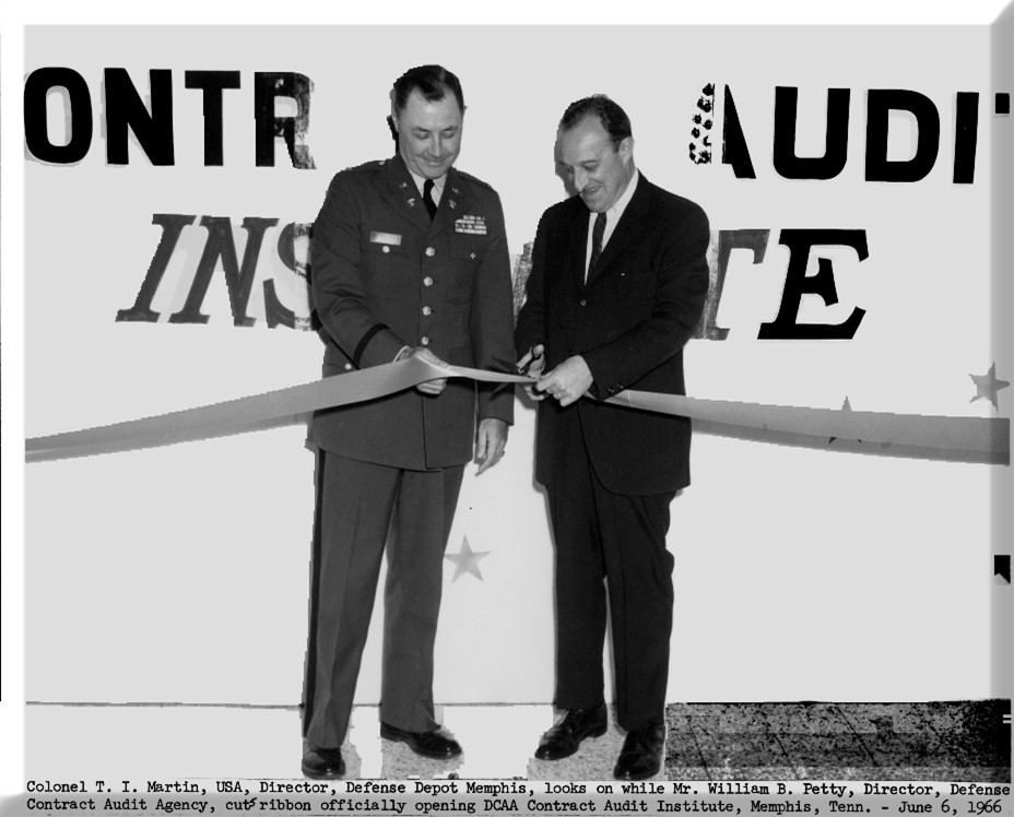 Two people cutting a ribbon at the Defense Contract Audit Institute grand opening.