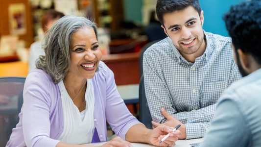 Older women talking with two men