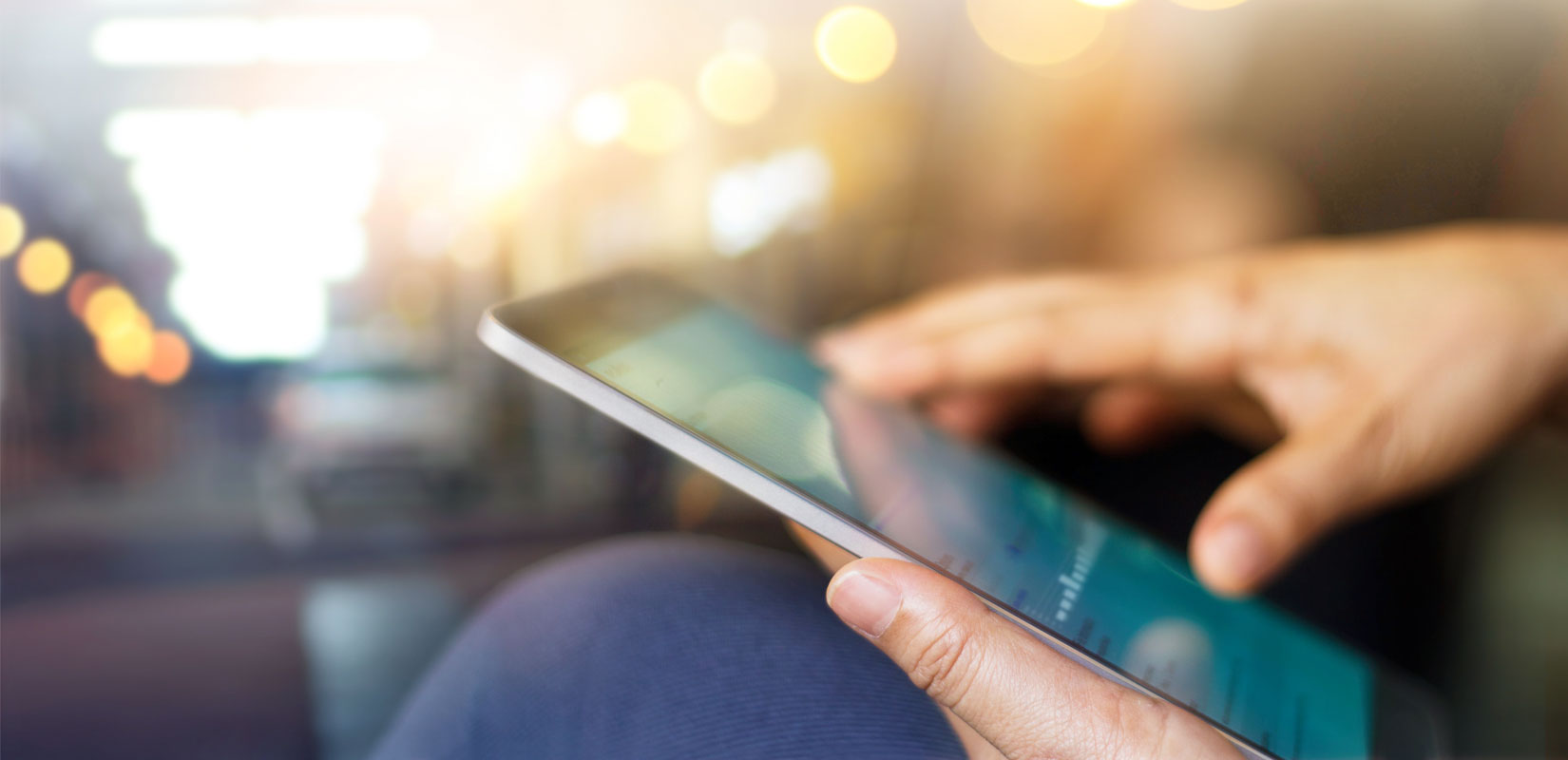 Hands holding a tablet