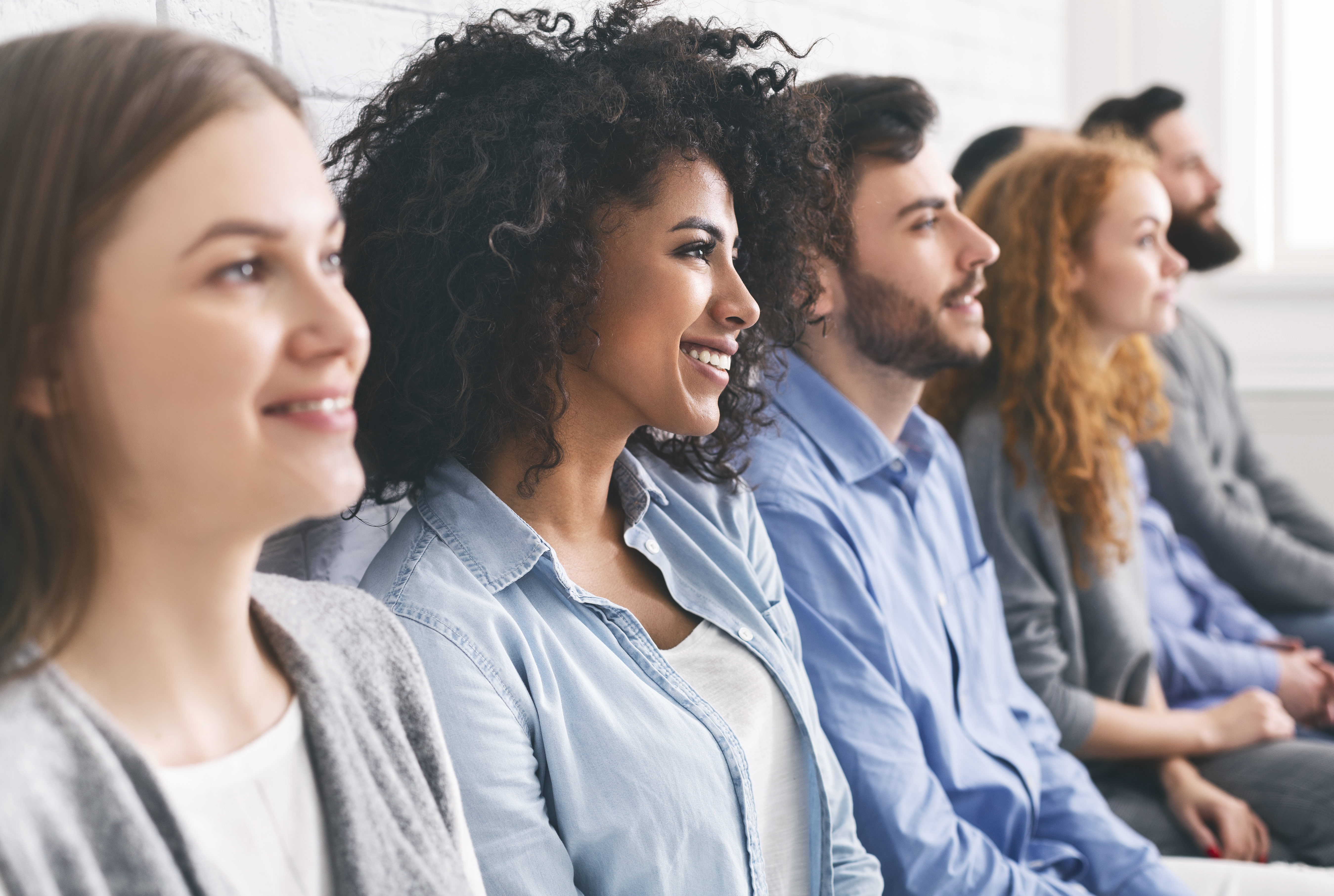 group of young professionals watching a presentation