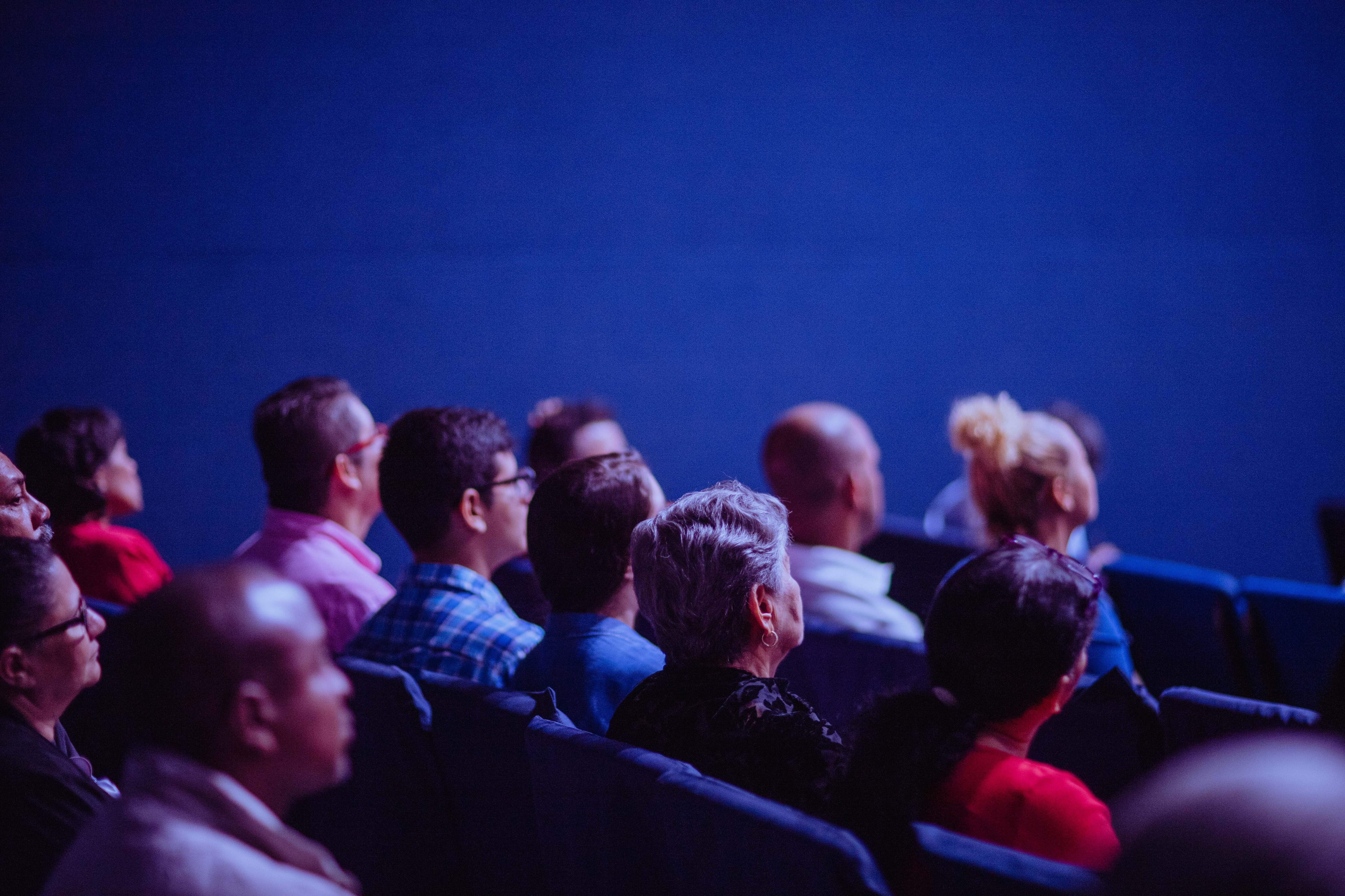 Group of people sitting in chairs at a conference